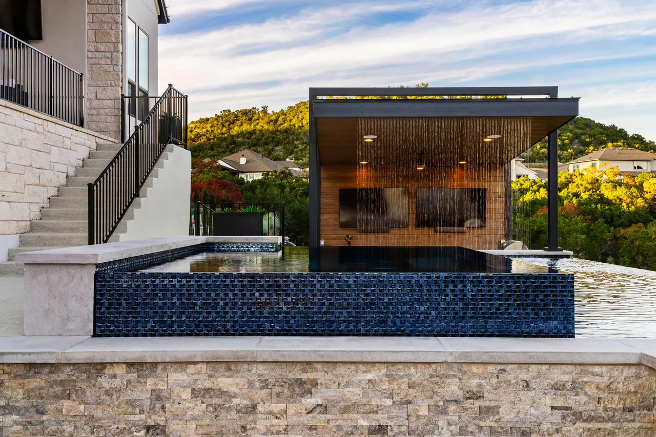 Vanishing-edge pool and cantilevered cabana on a canyon rim by GB IV Designs, Austin