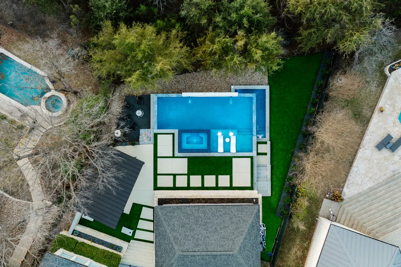 The same courtyard from above: pool, cabana and stepping pads through the lawn