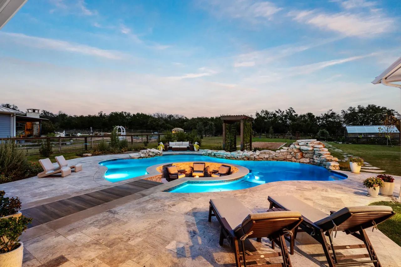 Farmhouse Lagoon — Freeform pool with sunken lounge in Travis County, TX by GB IV Designs (photo 2)