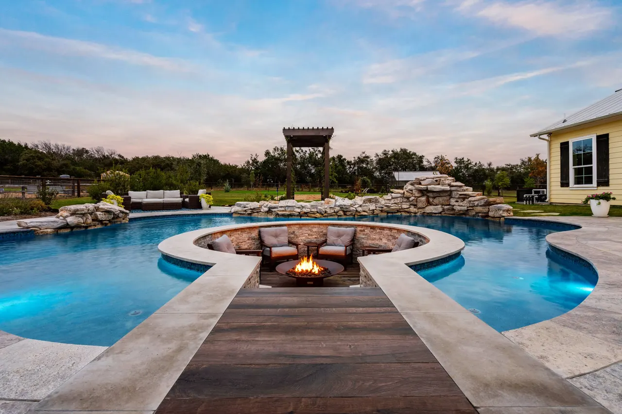 Farmhouse Lagoon — Freeform pool with sunken lounge in Travis County, TX by GB IV Designs