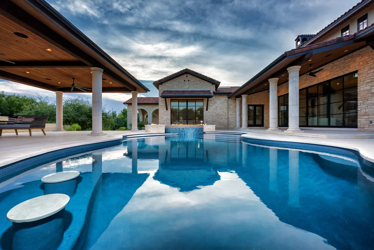 Villa courtyard pool with fire ring spa by GB IV Designs